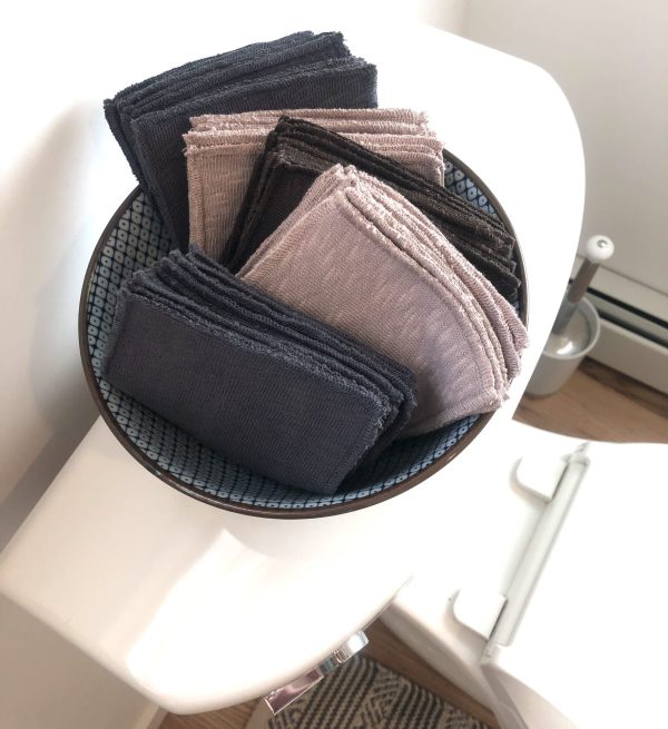 Nude-colored and Slate Grey variety pack displayed in beautiful bowl on the back of the toilet